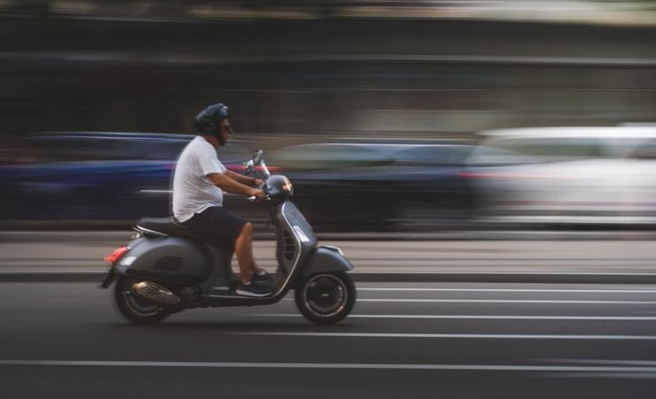 man-in-white-shirt-and-black-pants-riding-on-black-motor-scooter_cdd0a4b9592624ac201163c2b07496bb_800